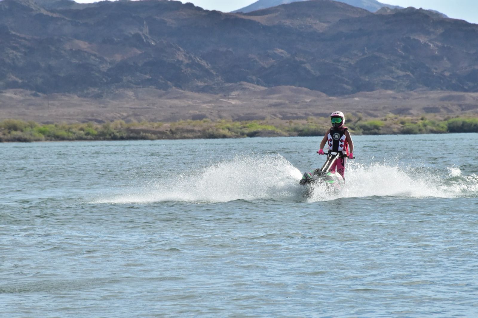A personal watercraft on Lake Havasu with desert mountains behind