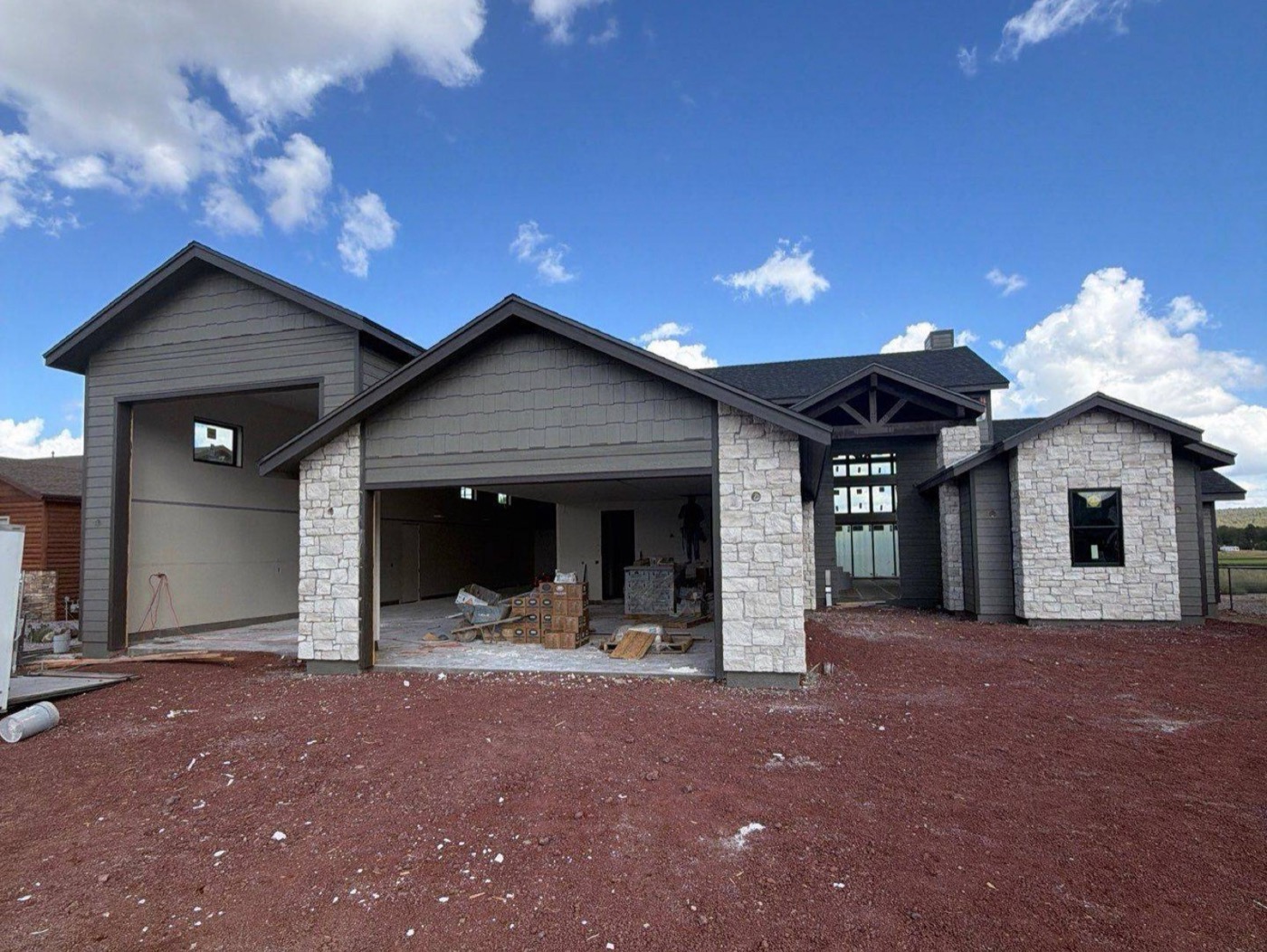 111 Highland Meadows under construction in Williams, AZ, with stone facade and RV garage