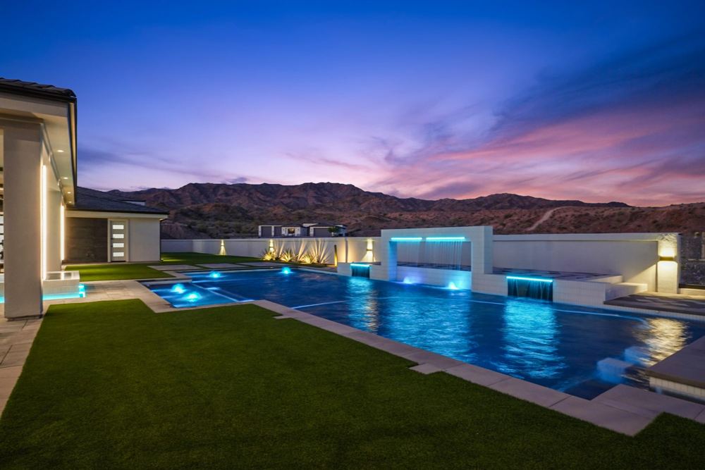 Pool and water feature at twilight with mountain views
