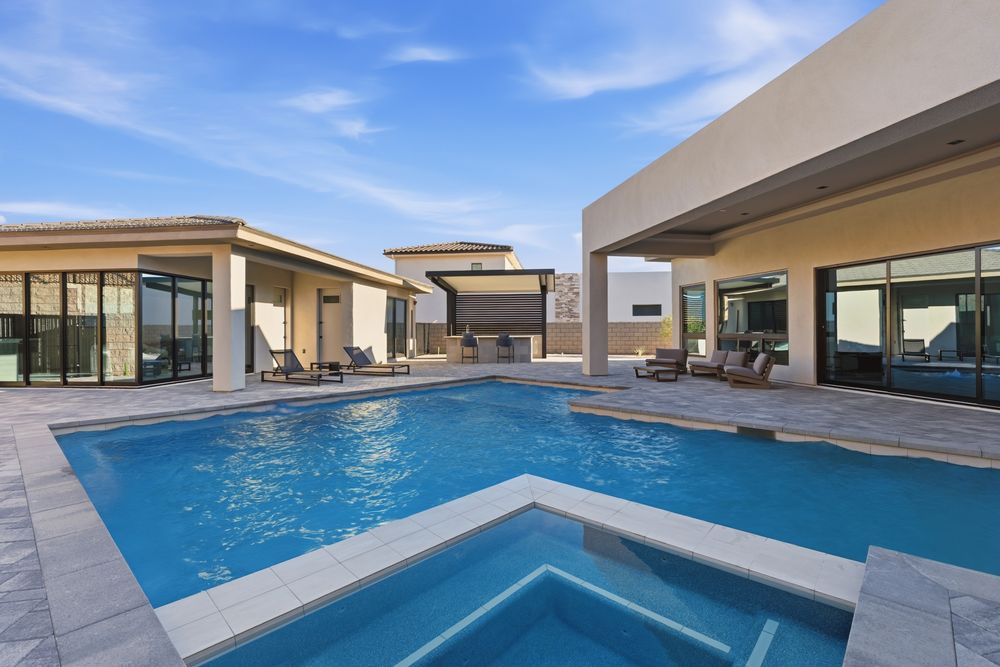 Pool and spa with the main house, casita and outdoor kitchen behind