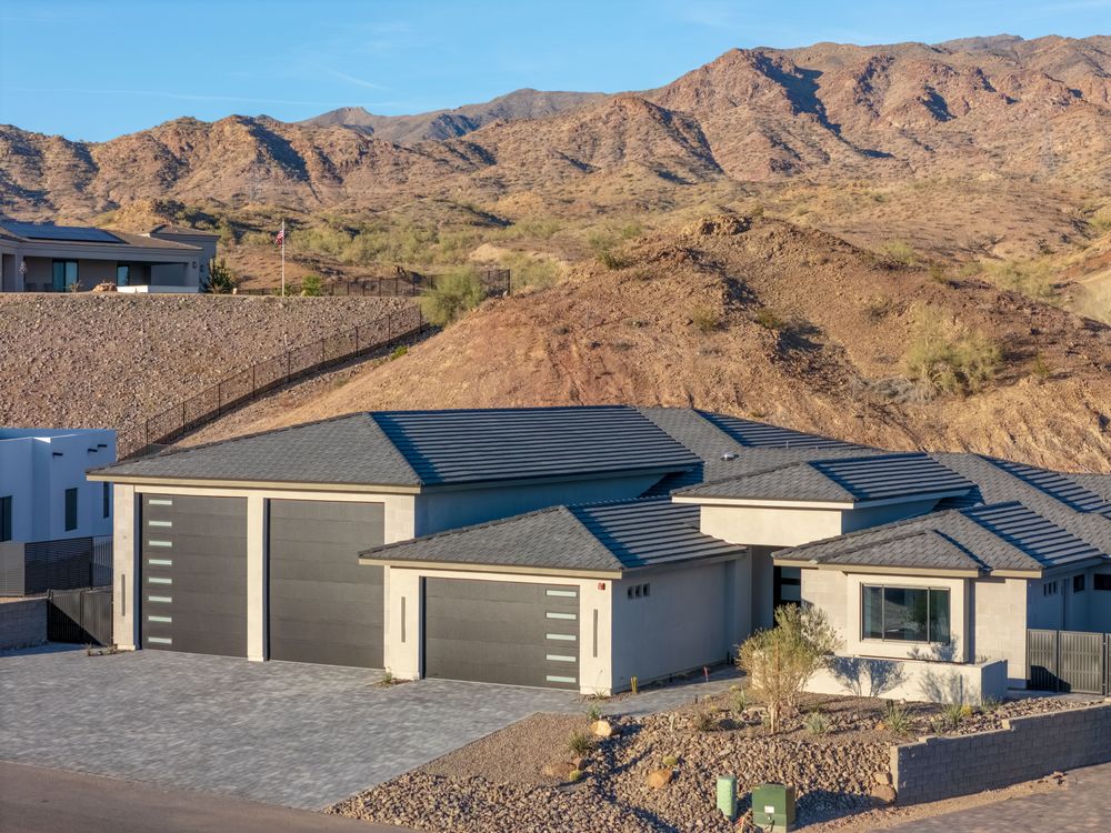 Front of the home and RV garage with the mountains behind