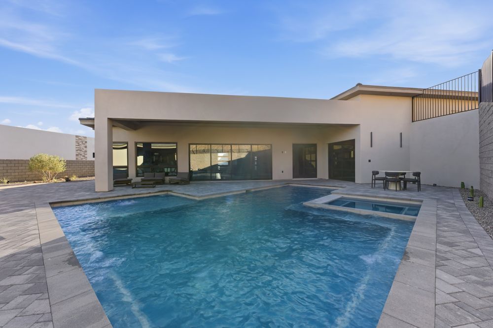 Pool and spa in front of the covered patio