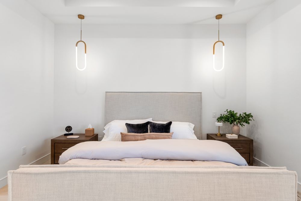 Primary bedroom with pendant lights