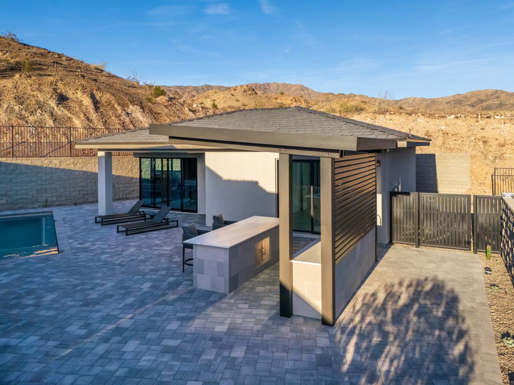 Outdoor kitchen shade structure beside the pool