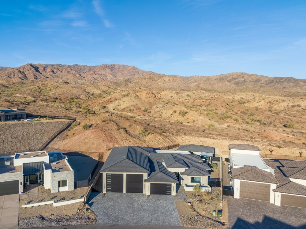 Aerial view of the home with the mountains behind
