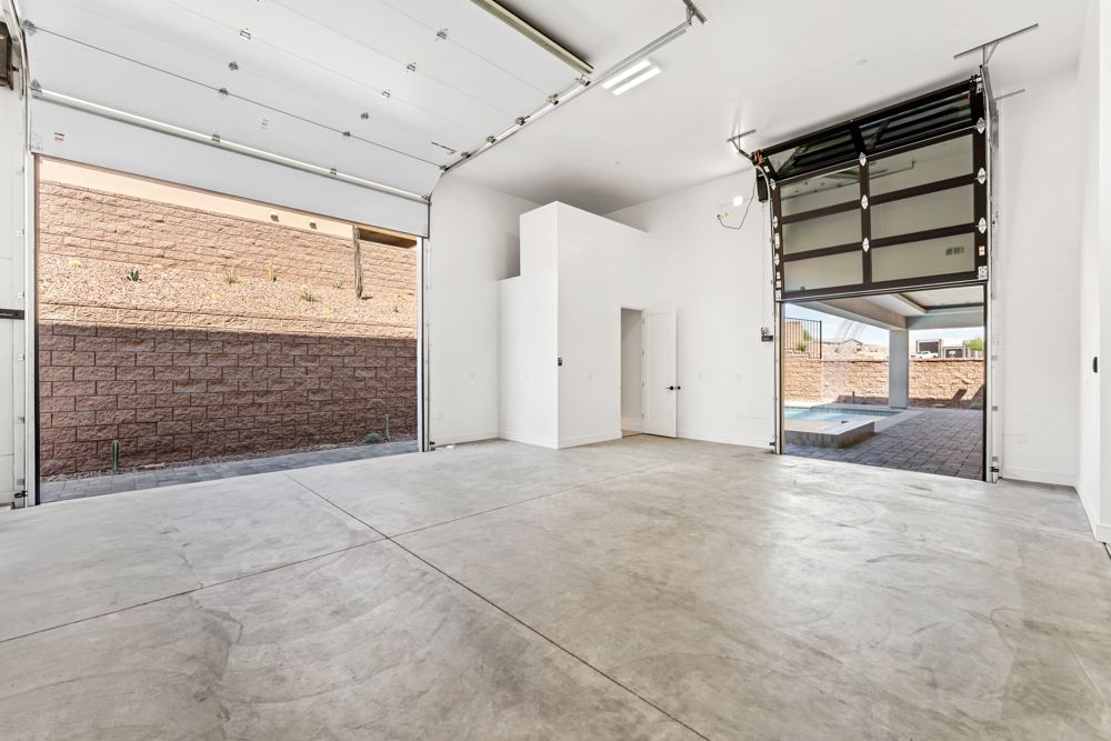 Motorhome garage with the front and rear doors open, looking through to the backyard
