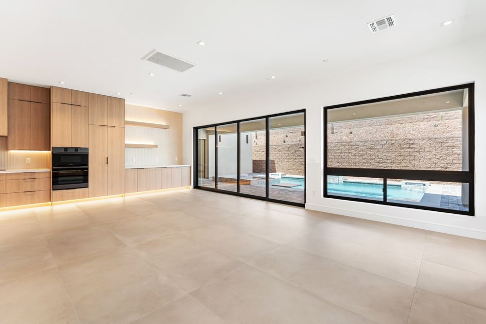 Great room opening to the kitchen with the pool visible through the sliders