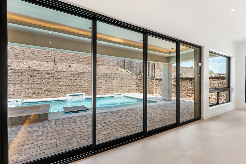 Wall of sliding glass doors onto the pool