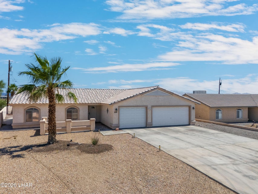 Front exterior of 618 Riverboat Dr with RV garage