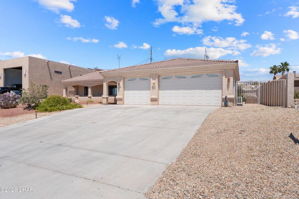 Front exterior of 720 Desert View Dr with three-car garage