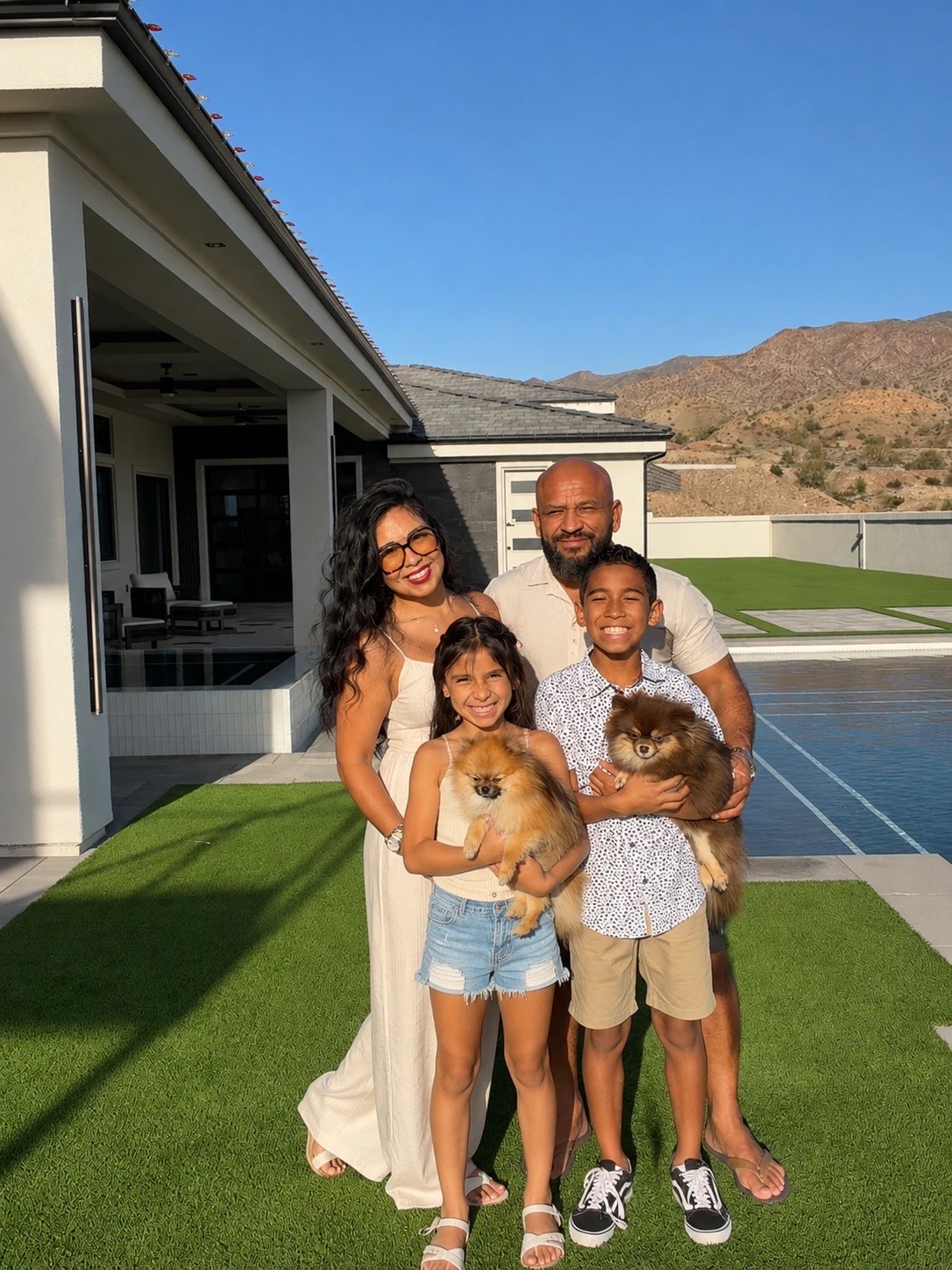 Jovian and Jose Moran with their son, daughter and two Pomeranians in their backyard in Lake Havasu City